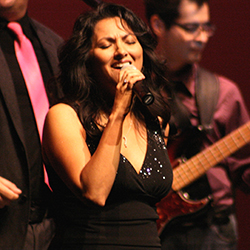 Tina Herbeck singing into a microphone
