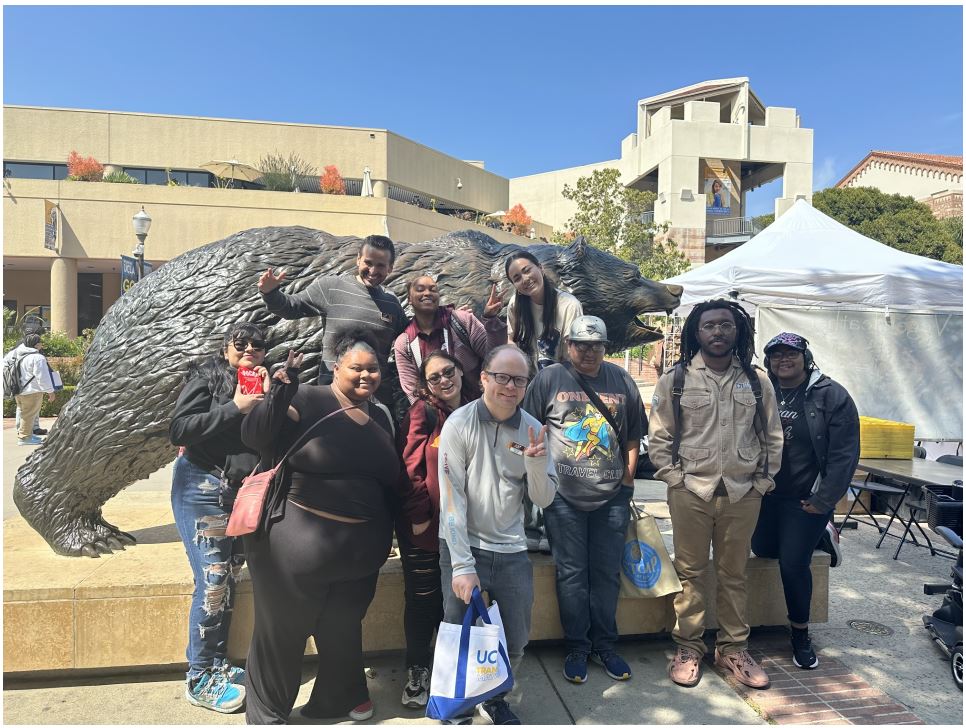 Students in front of UCLA Bruins bear statue.