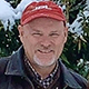 Time Etherington smiling wearing a red cap.