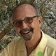Richard Fleishman smiling wearing a yellow shirt.
