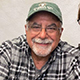 Joseph Lombardi smiling in a baseball cap.