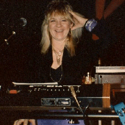 Peggy Martindale behind a microphone