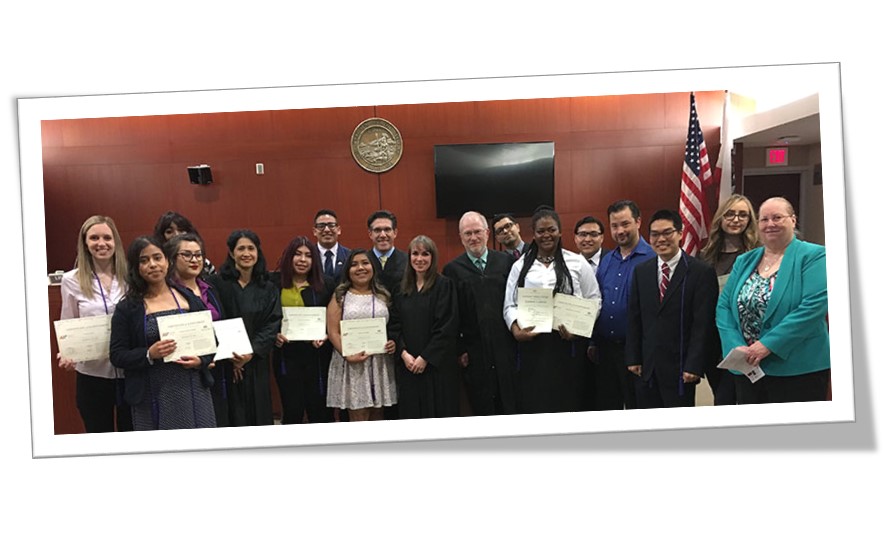 law scholar graduates with judges posing with certificates