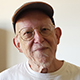 Eugene Siegel smiling in a baseball cap.