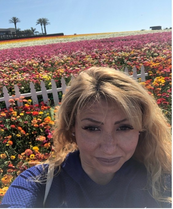 Mentor Amy Ledesma in a field of flowers.