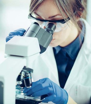 Student looking through microscope