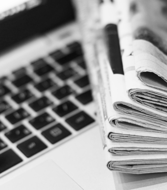 Newspaper on top of laptop