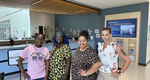 The Learning Center team stands by their front counter in Sage Hall. 